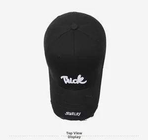 Top view of a black baseball cap with white Trick and JEWELRY embroidery on the brim