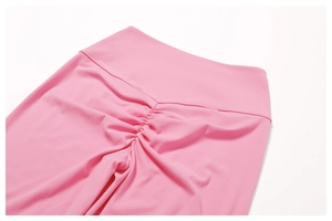 Detail view of pink high-waisted yoga pants with scrunch butt lift texture on the back