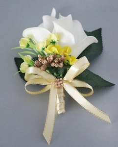 Detail of calla lily boutonniere with champagne ribbon, yellow accents and gold rhinestone