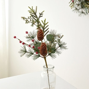 Artificial Christmas branch with pine cones, red berries, and needles in glass vase