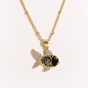 Close-up of golden goldfish pendant with clear crystals and black enamel on beaded chain
