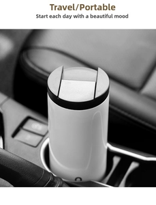 Minimalist white stainless steel coffee cup placed in a black car central cup holder