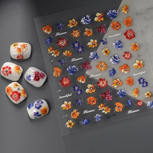 5D embossed floral nail stickers with colorful flowers on white artificial nails
