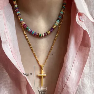 Detailed layered look of 18k gold cross pendant and colorful stone beaded necklace
