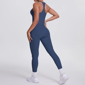 Detail of navy blue racerback sports bra and high-waisted yoga pants on a female model