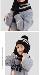 Detail of kids winter knit set featuring striped scarf, gloves, and pompom beanie