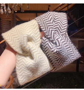 Close-up of knit headband featuring a twisted knot and textured chevron pattern