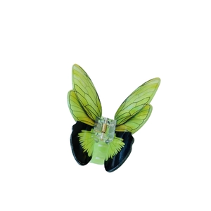 Front view of a green and black acrylic butterfly hair claw clip on white background