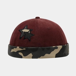 Macro view of vintage miki hat showing star embroidery and camo brim detail