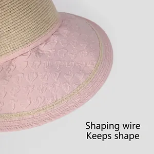 Pink floral fabric and beige straw sun hat with shape-retaining wire brim detail