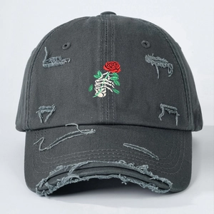 Dark grey distressed baseball cap with skull holding rose embroidery and torn detailing