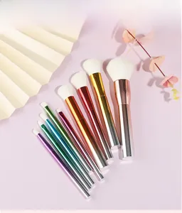 Detail view of 10 gradient metallic makeup brushes with soft white synthetic bristles