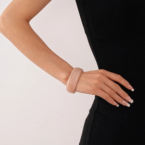 Close-up of pink marbled acrylic cuff bracelet with thick irregular resin design