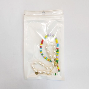 Detailed view of handmade natural crystal beads and pearls in a clear poly bag