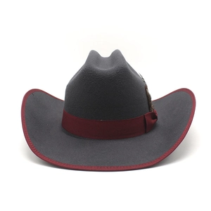 Detail of dark grey wool felt cowboy hat featuring a burgundy band and side feather accent