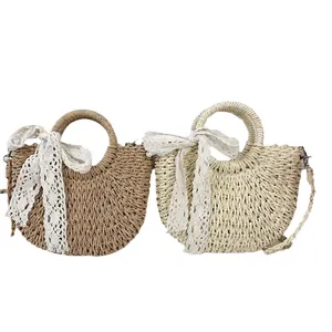 Handmade woven straw tote bag with lace bow decoration in khaki and cream colors