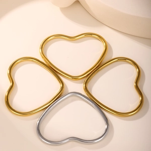 Macro detail of heart-shaped 18k gold and silver metal ring buckles for DIY jewelry