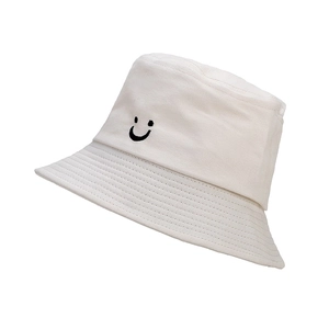 Close-up of cute smiley embroidery on white cotton sun hat with detailed stitching