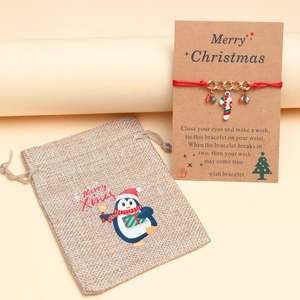 Handmade red rope wish bracelet with gold cane pendant, gift card and penguin linen pouch