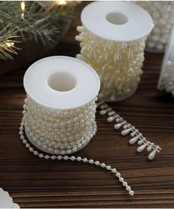 Detail of cream white pearl bead chain with teardrop pendants for Christmas DIY decor