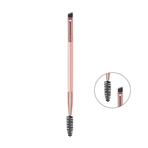 Detail of dual-ended pink eyebrow brush with angled bristle and spiral spoolie tip