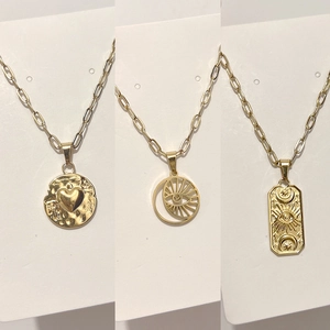 Golden heart and eye of providence pendant necklaces on modern paperclip link chains