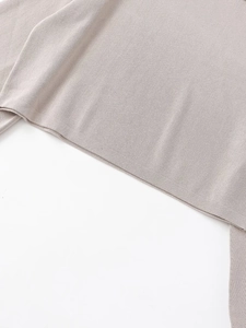Detailed macro view of the soft light gray knit fabric texture and hem on this sweatshirt