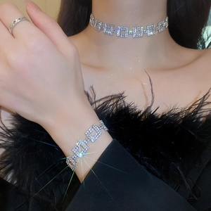 Close-up of sparkling silver hollow square rhinestone necklace and bracelet set
