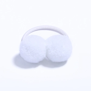 Detail showing two white fluffy pom poms on a high-elastic hair tie for kids