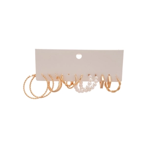 Set of six gold geometric hoop earrings and white pearl studs on a white card display