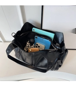 Spacious black pebbled leather tote interior showing organized daily essentials