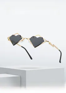Detail of heart-shaped sunglasses with gold lightning temples and black lenses