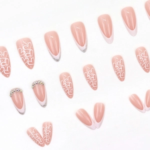 Long almond press-on nails with white French tips, silver glitter, and heart designs
