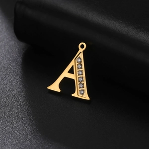 Macro shot of gold stainless steel letter A pendant with sparkling inlaid diamonds