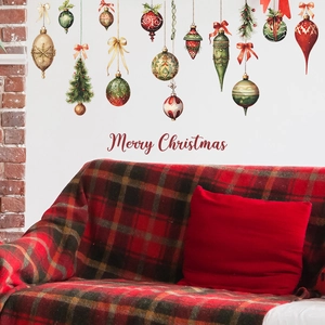 Detail of festive Christmas wall stickers with red and green baubles on a white wall