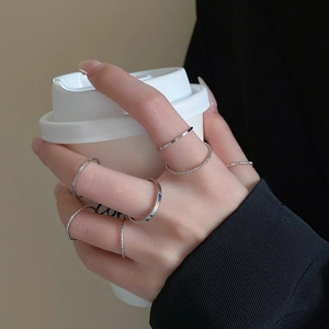 Set of six minimalist silver stacking rings featuring smooth and twisted rope textures