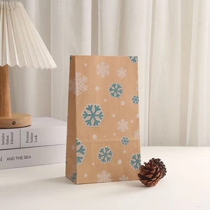 Brown kraft paper Christmas gift bag featuring blue and white snowflake patterns
