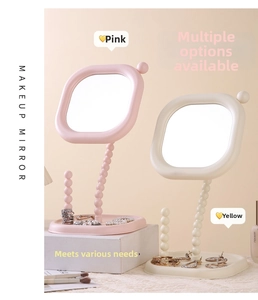 Macro detail view of cream pearl desktop makeup mirrors in pink and beige finishes