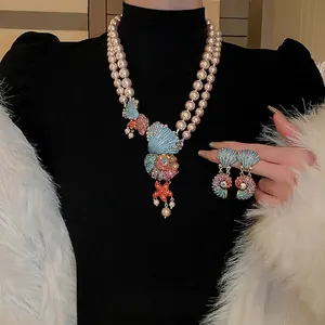 Double-layered pearl necklace and earrings set with crystal shells and starfish