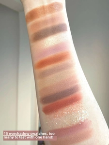 Arm swatches of 15 eyeshadow shades showing matte, shimmer and glitter textures