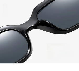 Close-up of integrated nose pad design on black square sunglasses frame for women