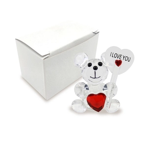 Detail view of crystal bear figurine holding 'I LOVE YOU' heart with gift box
