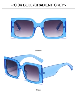 Detail view of square oversized sunglasses with blue transparent frame and gradient grey lens