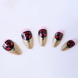 Halloween almond press-on nails with glitter French tips and black pumpkin face designs