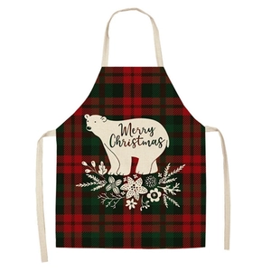 Close-up of red plaid Christmas apron featuring white polar bear and Merry Christmas print