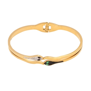 Gold plated stainless steel snake bangle with cubic zirconia crystals and green eyes