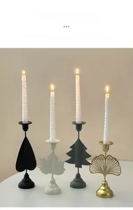 Macro view of creative leaf-shaped iron candle holders in black gold and white finishes