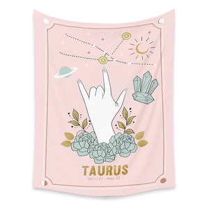 Detail of Taurus zodiac tapestry with floral graphics and golden celestial astrology symbols