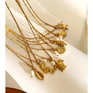 Gold plated ocean theme necklace set with pearls, starfish, seashell and seahorse pendants
