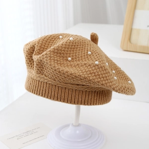 Detailed close-up of khaki knit beret with pearls and gold wire texture for girls